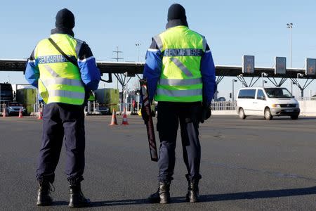 Armed French gendarmes stand next to a toll station as they check vehicles and verify the identity of travellers on the A2 motorway between Paris and Brussels near Thun L'Eveque, France, January 25, 2016. REUTERS/Pascal Rossignol