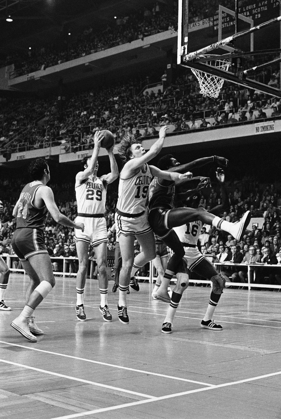 Hank Finkel of the Boston Celtics lays up a shot as Celtics Don Nelson (19) collides with <a class="link " href="https://sports.yahoo.com/nba/teams/new-york/" data-i13n="sec:content-canvas;subsec:anchor_text;elm:context_link" data-ylk="slk:New York Knickerbockers;sec:content-canvas;subsec:anchor_text;elm:context_link;itc:0">New York Knickerbockers</a> Earl Monroe, in their National Basketball Association semifinals playoff game in the afternoon on Sunday, April 23, 1972, at Boston Garden. New York won 111-103 to win the series 4-1. (A Photo)