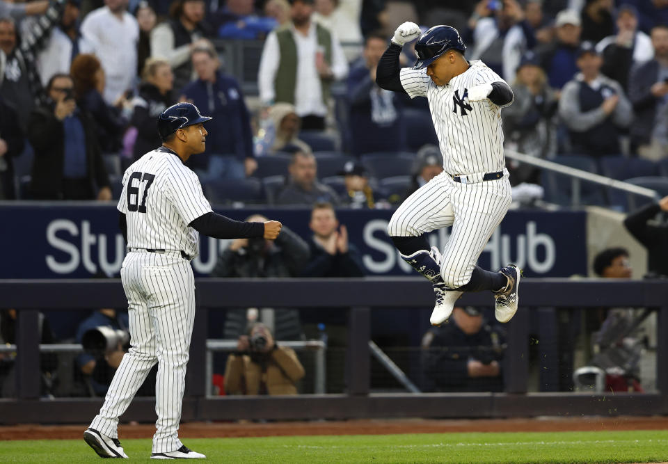 New York Yankees' Juan Soto, right, reacts in front third base coach Luis Rojas (67) after hitting a home run against the Miami Marlins during the fourth inning of a baseball game, Monday, April 8, 2024, in New York. (AP Photo/Noah K. Murray)