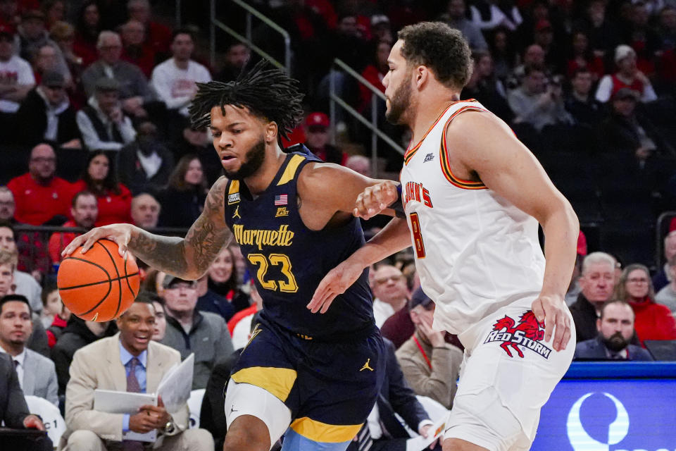 Marquette forward David Joplin (23) drives to the basket against St. John's guard Chris Ledlum (8) during the first half of an NCAA college basketball game in New York, Saturday, Jan. 20, 2024. (AP Photo/Peter K. Afriyie)