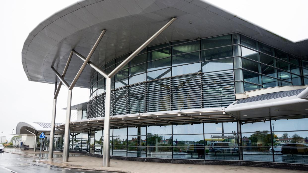 The outside Guernsey Airport, a modern-looking, glass-front building.