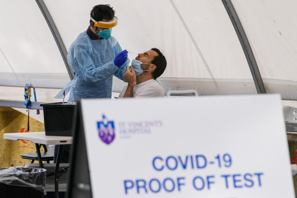 FILE - A man receives a COVID-19 test in the eastern suburbs of Sydney Tuesday, Sept. 14, 2021. On Friday, July 14, The Associated Press reported on stories circulating online incorrectly claiming new data on the numbers of births in the Australian state of New South Wales shows that coronavirus vaccines “destroyed” human fertility. (AP Photo/Mark Baker, File)