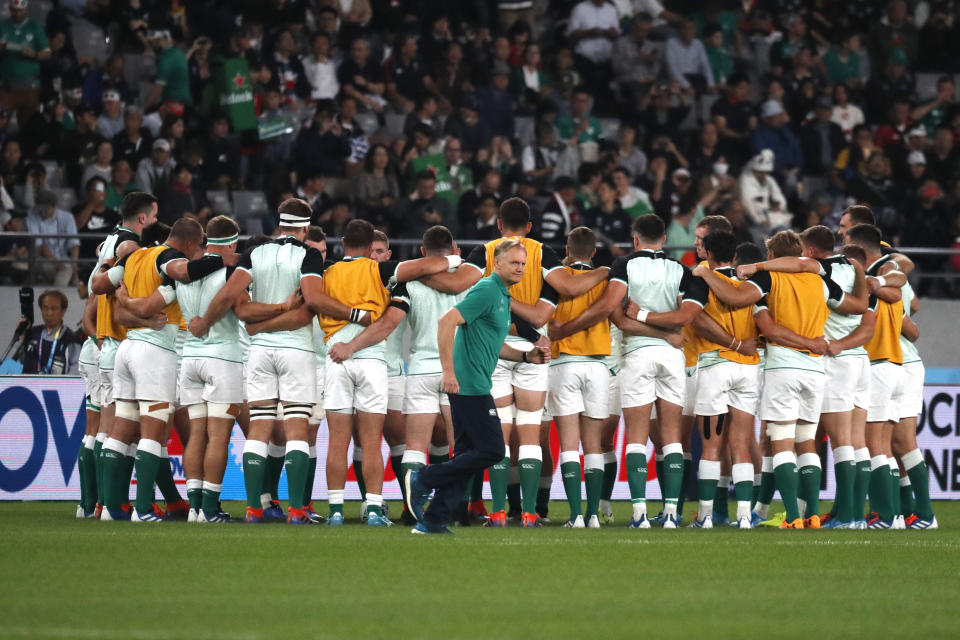 Ireland coach Joe Schmidt moves past his players ahead of the Rugby World Cup quarterfinal match at Tokyo Stadium between New Zealand and Ireland in Tokyo, Japan, Saturday, Oct. 19, 2019. (AP Photo/Eugene Hoshiko)