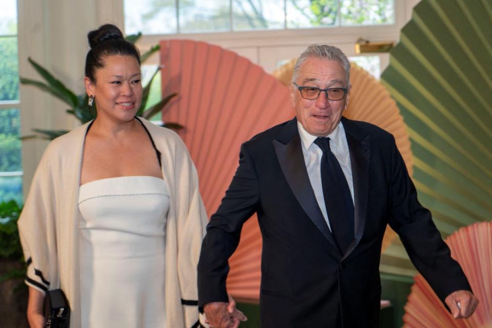Hollywood actor and outspoken Mr Trump critic De Niro arrived hand in hand with his girlfriend, Tiffany Chen (Reuters)