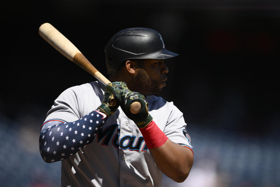 Miami Marlins' Jesus Aguilar wears a patriotic themed arm sleeve during his at bat in the first inning of a baseball game against the Washington Nationals, Monday, July 4, 2022, in Washington. (AP Photo/Nick Wass)