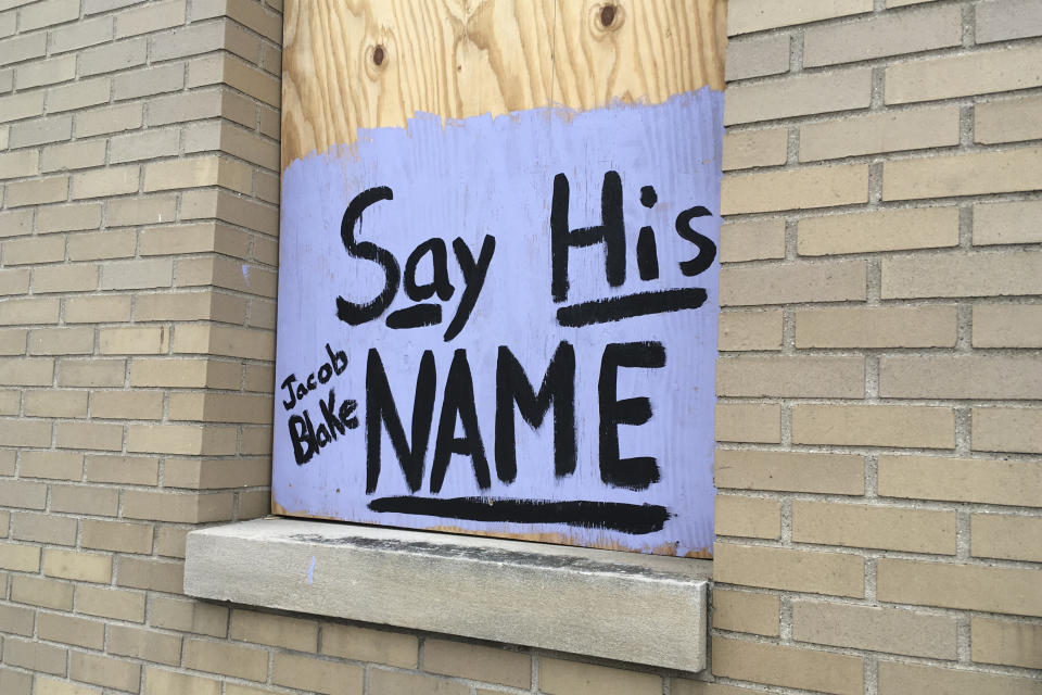 A sign in support of Jacob Blake is displayed on a boarded up window in Kenosha, Wis., Thursday, Jan. 7. 2021. The chaotic protests that everyone feared would ensue after a prosecutor decided this week not to charge a Wisconsin police officer who shot Jacob Blake, a Black man, in the back haven't materialized as activists bide their time after right-wing extremists stormed the U.S. Capitol. (AP Photo/Mike Householder)