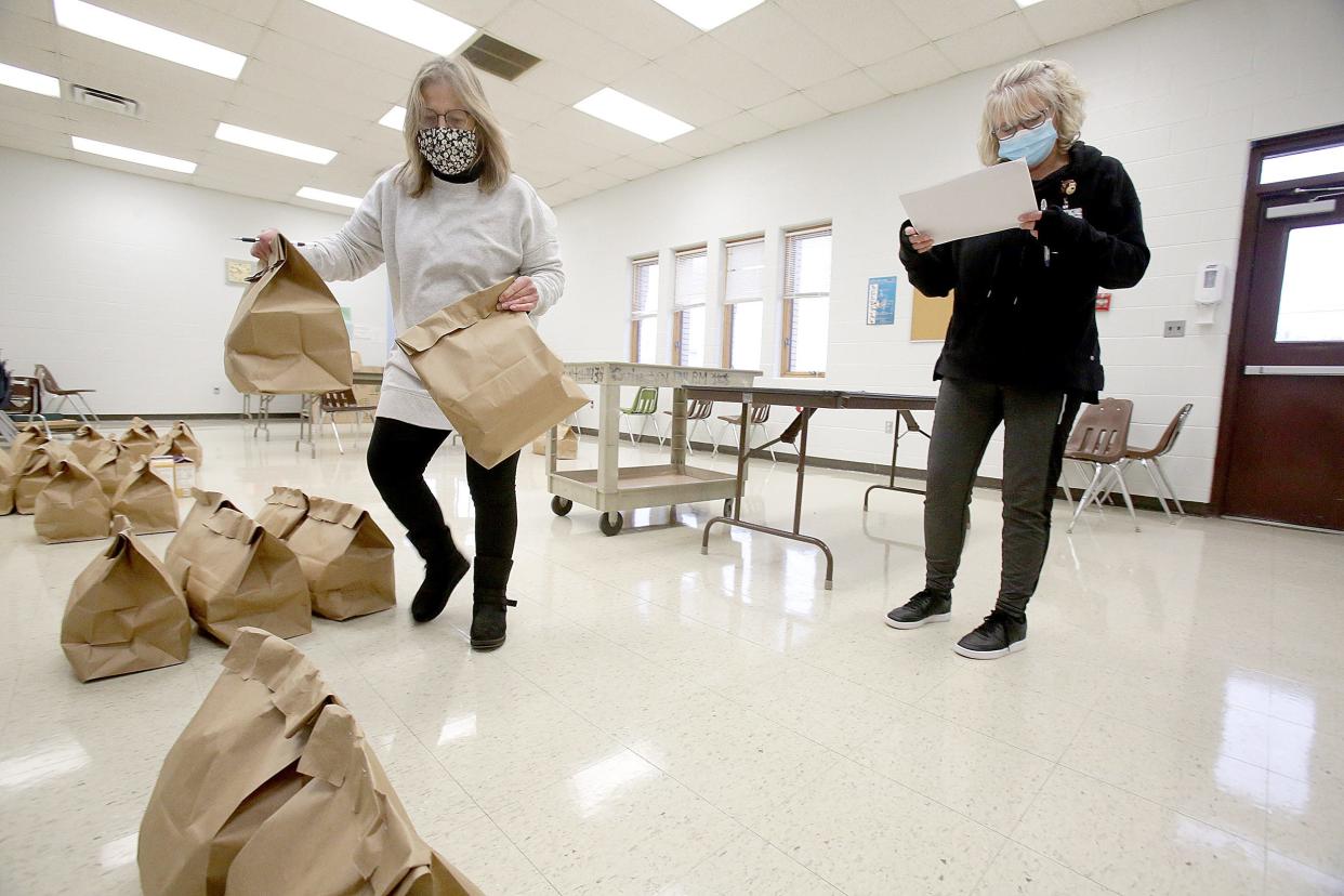 Diane Sidwell, a transportation manager, right, along with Barb Malcom a transportation rider, prep 75 meals that will be delivered for children with developmental disabilities at Southgate School in Canton.