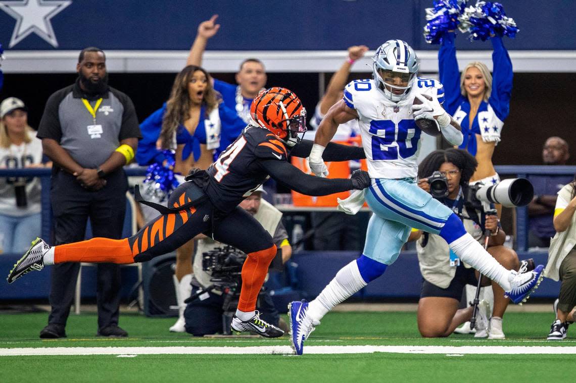 Dallas Cowboys running back Tony Dollar outruns the Cincinnati Bengals safety Vonn Bell during the first quarter on Sunday, Sept. 18, 2022, at the AT&T Stadium in Arlington, Texas.