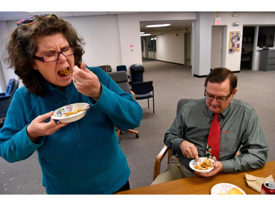 Anticipating the taste, Laura Gutschke grimaces as she takes a fork-full of canned beef tamale with chili sauce Dec. 22, 2017. The first-ever Abilene Reporter-News Shuck-off was held in the newsroom to measure the quality of available tamales when you've got nowhere else to turn.