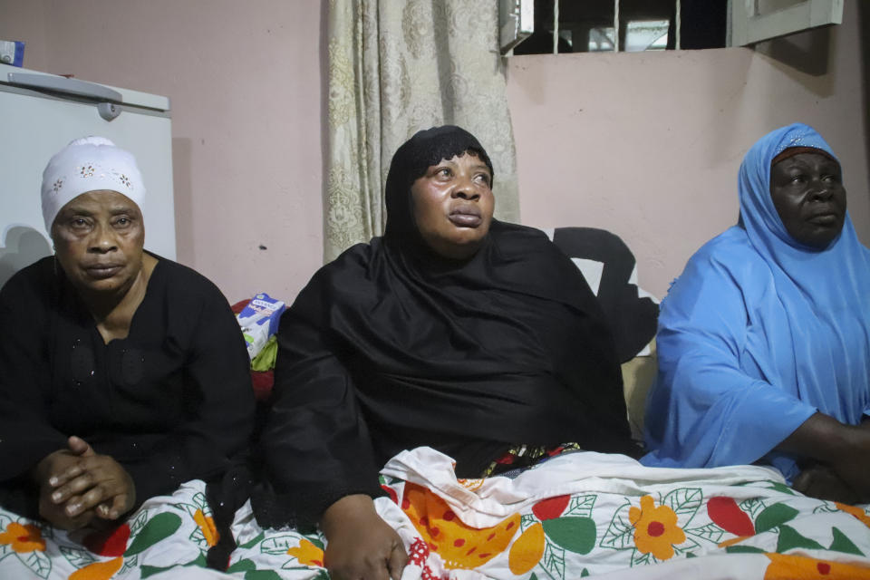 Asina Selemani, center, the widow of World Food Programme (WFP) driver Moustapha Milambo, who was killed in the attack on a U.N. convoy that also killed the Italian ambassador to Congo and an Italian Carabinieri police officer, sits at her home in Goma, North Kivu province, Congo, Tuesday, Feb. 23, 2021. An Italian Carabinieri unit is expected in Congo Tuesday to investigate the killings of the Italian ambassador to Congo, an Italian Carabinieri police officer and their driver in the country's east. (AP Photo/Justin Kabumba)
