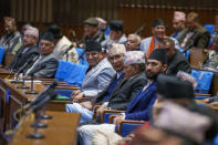 Nepalese Prime Minister Pushpa Kamal Dahal, center, gestures before taking the vote of confidence in Nepal's parliament in Kathmandu, Nepal, Tuesday, Jan. 10, 2023. Nepal's newly appointed prime minister has secured the vote of confidence in parliament with support from both members of his coalition parties and the opponent groups.(AP Photo/Niranjan Shrestha)