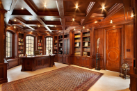 The richly paneled library is just off the grand foyer to the left. (The home has three foyers.)