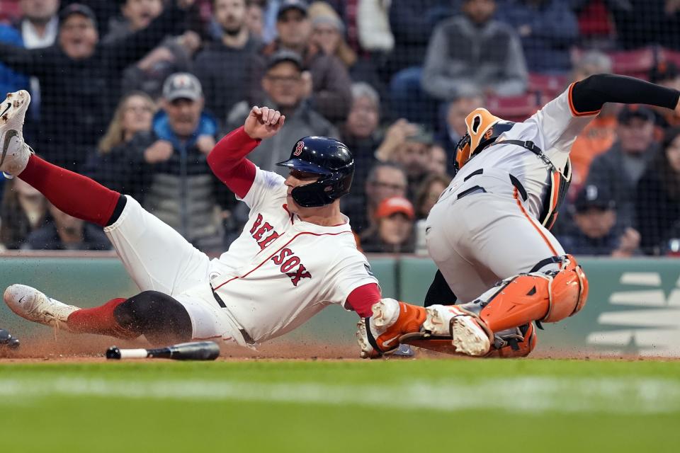 Boston Red Sox's Tyler O'Neill scores against San Francisco Giants catcher Patrick Bailey, right, on an single by Rob Refsnyder during the first inning of a baseball game, Tuesday, April 30, 2024, in Boston. (AP Photo/Michael Dwyer)