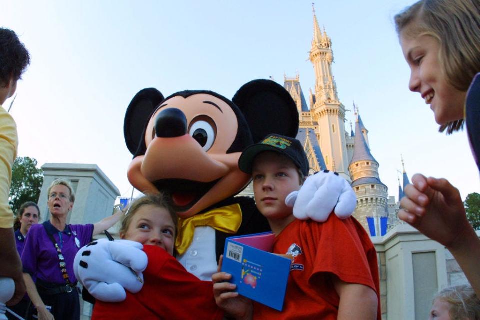 Guests get their close-up with Mickey Mouse in this file photo from Nov. 2001.