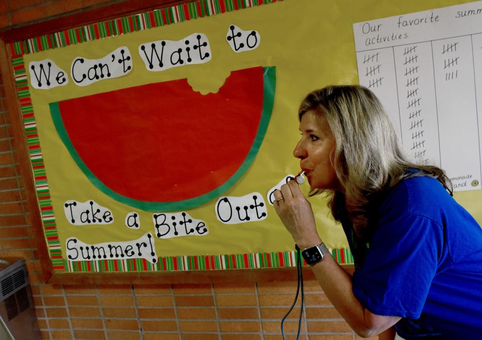 Ida Elementary kindergarten teacher Sherry Locke blows the whistle for the students to change classes as different activities were planned in the kindergarten and young fives classrooms on the last day of school.