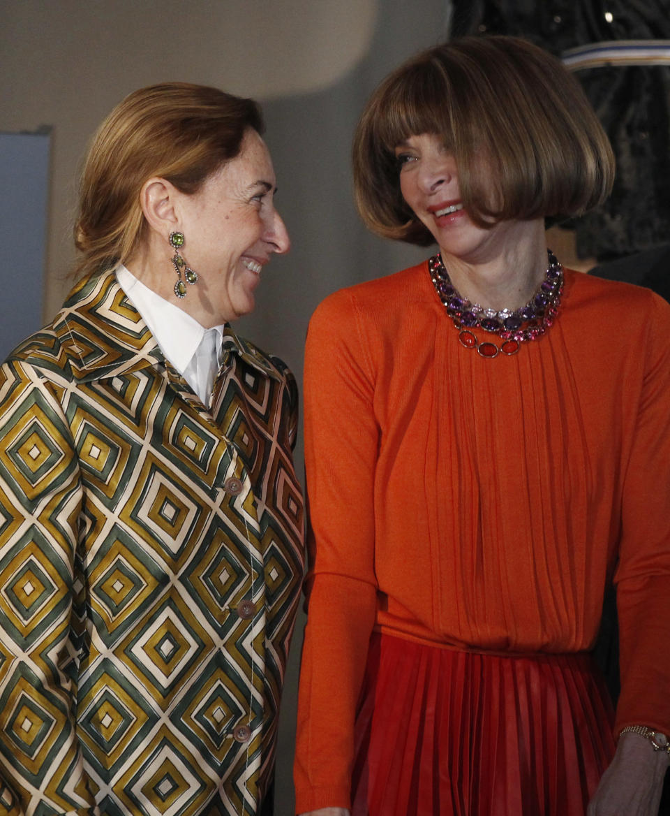 American Vogue's editor-in-chief Anna Wintour, right, talks to Italian fashion designer Miuccia Prada during the presentation of the fashion exhibition "Impossible Conversations" in Milan, Italy, Friday, Feb.24, 2012. The exhibition will take place at the Metropolitan Museum of Art in New York, from May 10 to August 19, 2012. (AP Photo/Luca Bruno)