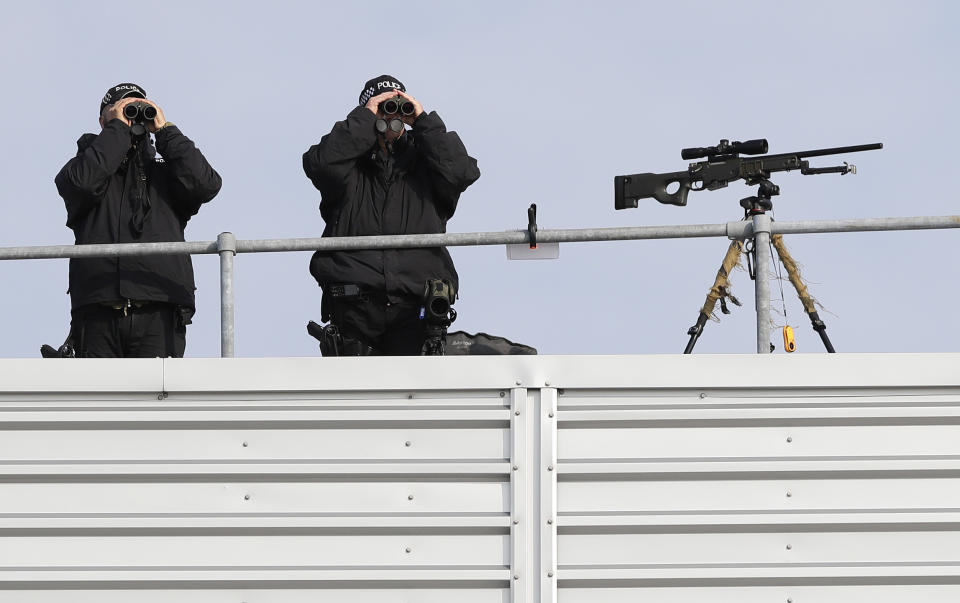 Police marksmen scan the area as they await the arrival of President Donald Trump and first lady Melania Trump at Stansted Airport in England, Monday, June 3, 2019 at the start of a three day state visit to Britain. (AP Photo/Kirsty Wigglesworth)