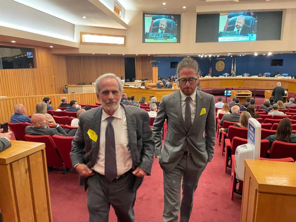 Leonard Abess Jr., left, and his son, Matthew Abess, exit the Miami-Dade County Commission chambers on May 19, 2022, after the elder Abess urged the board to reject expanding the Urban Development Boundary to include 160 acres of farmland he owns.