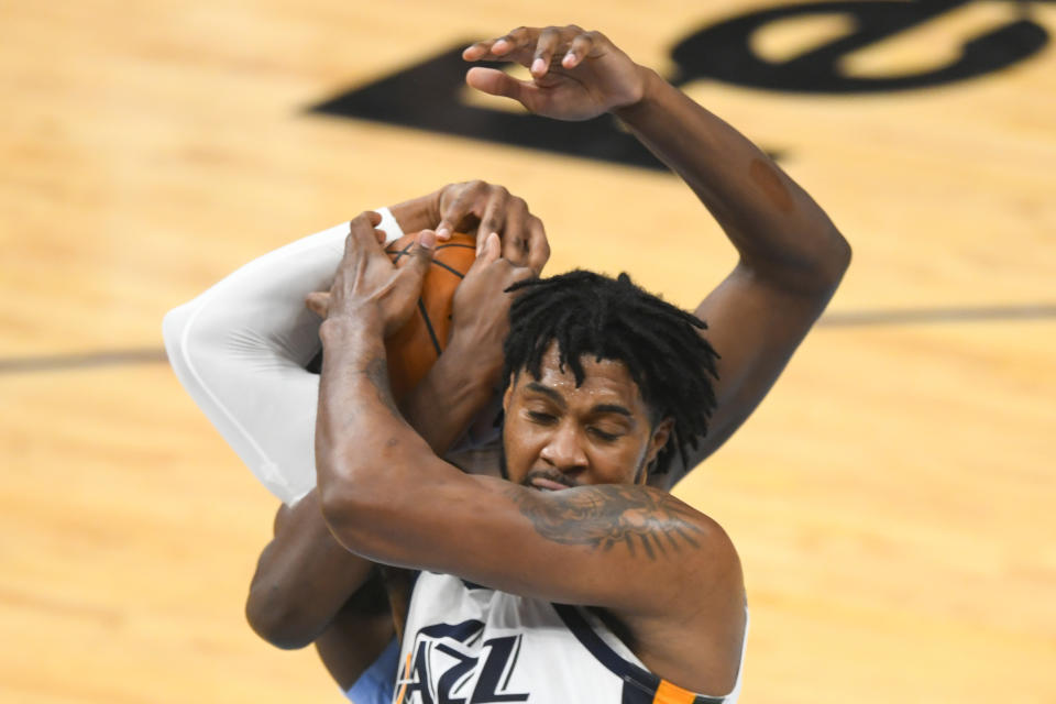 Utah Jazz center Derrick Favors ties the ball up with Memphis Grizzlies forward Jaren Jackson Jr. during the first half of Game 3 of an NBA basketball first-round playoff series Saturday, May 29, 2021, in Memphis, Tenn. (AP Photo/John Amis)