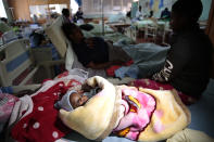 Klavan Munyisa who is 3 months old lays in a hospital bed after surviving a bus crash in Rusape about 170 kilometres east of the capital Harare, Thursday, Nov. 8, 2018. A head-on collision between two buses has killed 47 people, where road accidents are common due to poor roads and bad driving. (AP Photo/Tsvangirayi Mukwazhi)