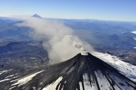 An aerial view shows smoke and ash rising from Villarrica Volcano, south of Santiago March 18, 2015. REUTERS/Stringer