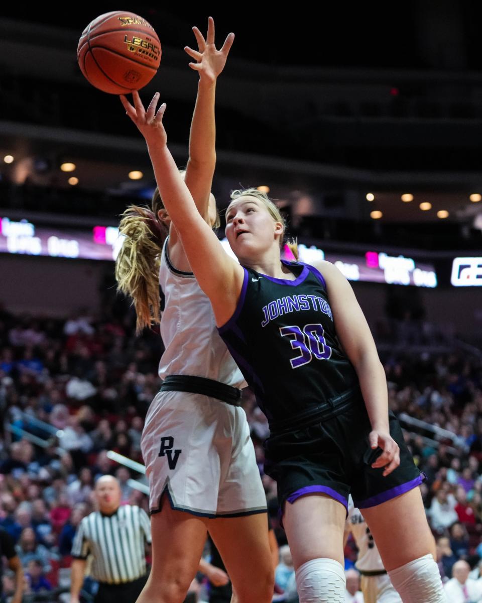 Johnston guard Aili Tanke (30) goes up for a layup against Pleasant Valley forward Quinn Vice during Friday's Class 5A state championship game.