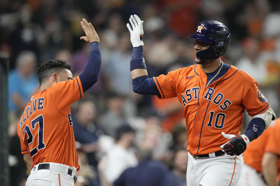 Houston Astros' Yuli Gurriel (10) celebrates with Jose Altuve (27) after hitting a home run against the Seattle Mariners during the third inning of a baseball game Friday, Aug. 20, 2021, in Houston. (AP Photo/David J. Phillip)