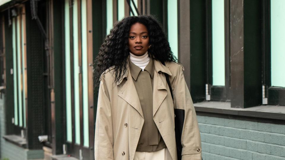 Woman wearing a trench coat with boxy jacket 