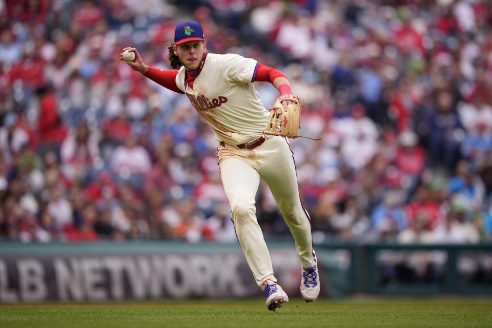 Philadelphia Phillies third baseman Alec Bohm throws to first base after fielding a ground out by Chicago White Sox's Andrew Benintendi during the fourth inning of a baseball game, Sunday, April 21, 2024, in Philadelphia. (AP Photo/Matt Slocum)