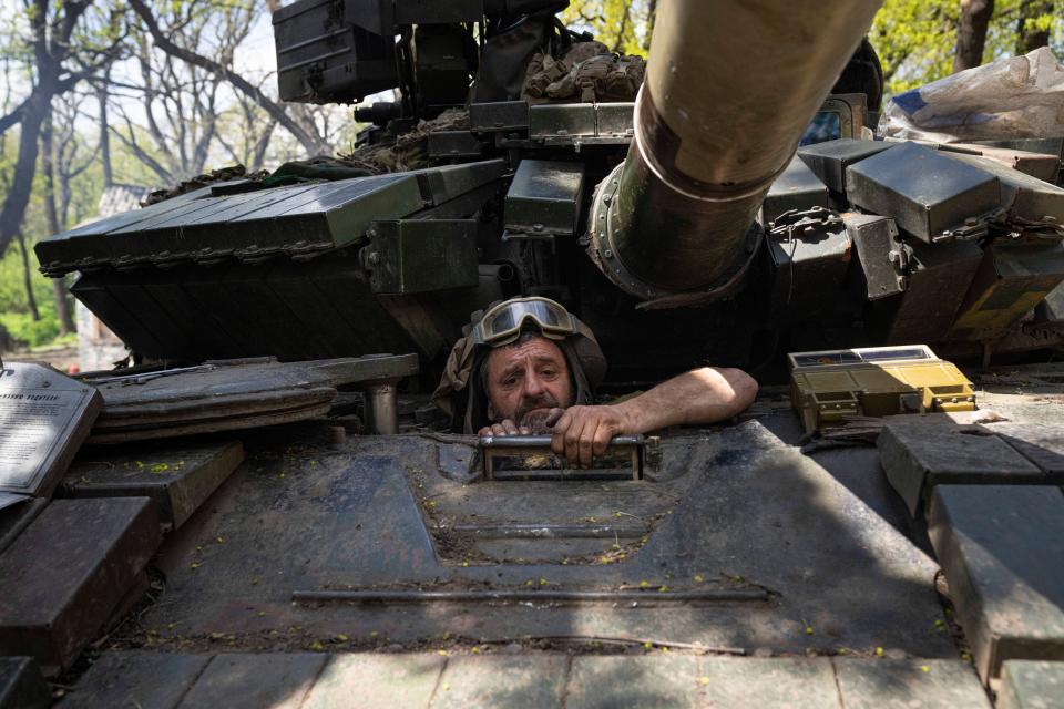 A Ukrainian serviceman repairing a tank in the Donetsk region of eastern Ukraine (Evgeniy Maloletka/AP)