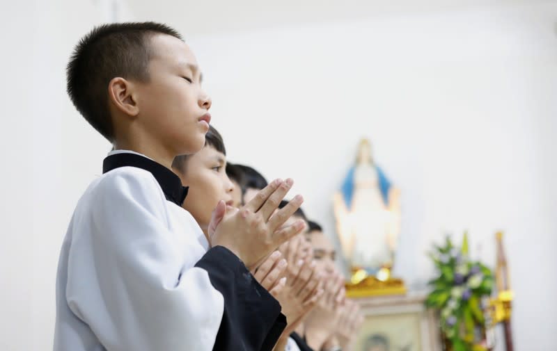 Catholics attend a mass prayer for 39 people found dead in the back of a truck near London, UK at My Khanh parish in Nghe An province