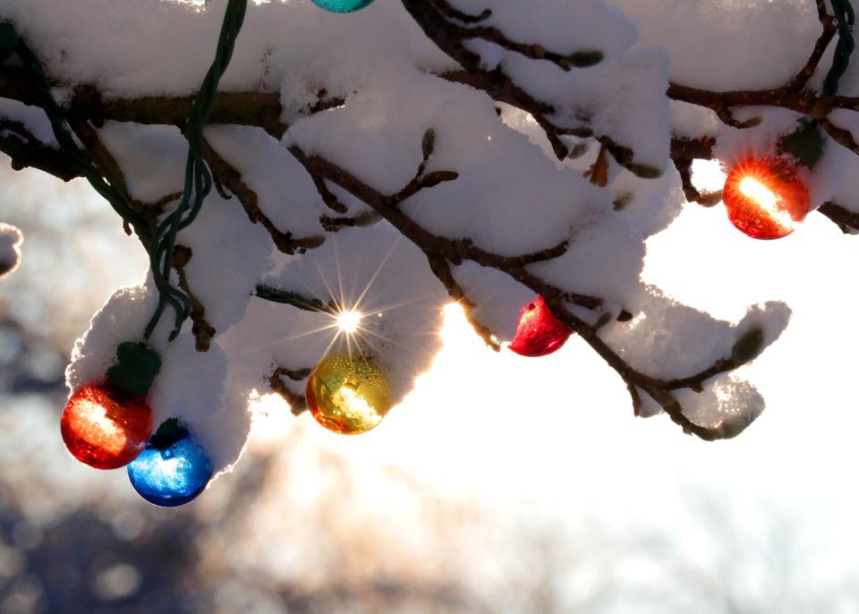 The sun peeks through snow covered Christmas lights in Bayside on Monday, Feb. 10, 2020. The area received 3-6 inches of fresh snow after Sunday's snowstorm. Photo by Mike De Sisti / Milwaukee Journal Sentinel 