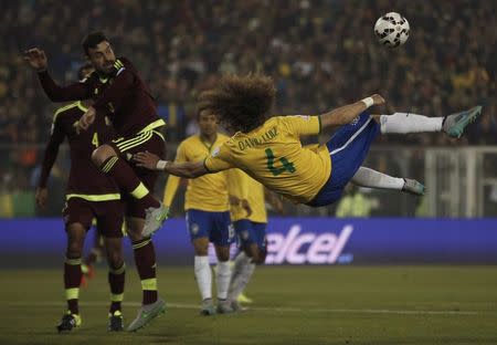 Brazil's David Luiz kicks the ball next to Venezuela's Andres Tunez during their first round Copa America 2015 soccer match at Estadio Monumental David Arellano in Santiago, Chile, June 21, 2015. REUTERS/Ivan Alvarado