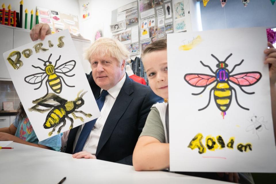 Prime Minister Boris Johnson shows off a picture he painted during a class at HideOut Youth Zone in Manchester (Stefan Rousseau/PA) (PA Wire)