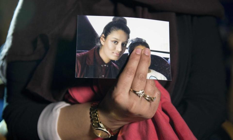 Shamima Begum sister holds a photo of her.