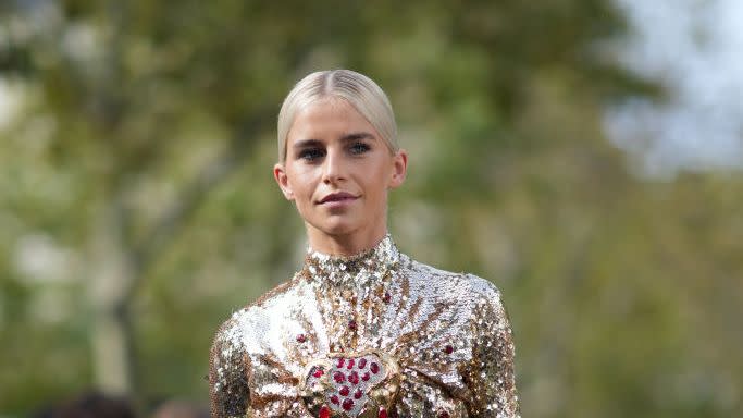 caroline daur wearing a gold sequin skirt and gold metal paco rabanne bag on the street during paris fashion week 2024 in a roundup of the best designer bags 2023