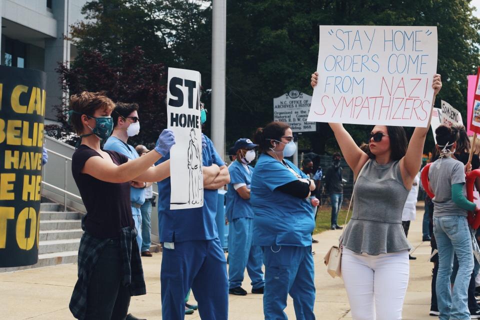 Health care workers staging a counterprotest at the ReOpen NC rally on Tuesday.  (Photo: Jade Wilson )