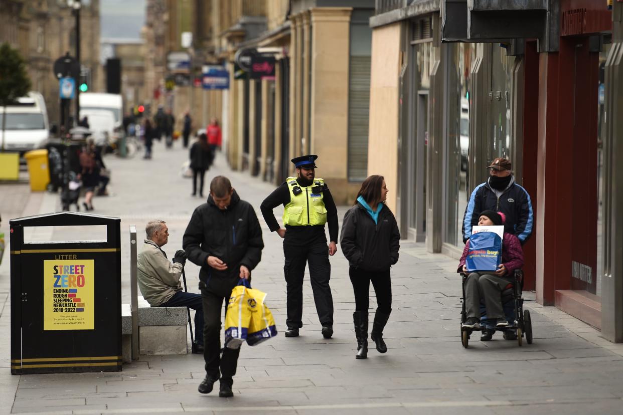 A police community support officer encourages people to socially distance in the centre of Newcastle upon Tyne, Thursday lunchtime in north-east England on April 9, 2020 as Britain continued to battle the outbreak of new coronavirus and the governement prepared to extend the nationwide lockdown. - The disease has struck at the heart of the British government, infected more than 60,000 people nationwide and killed over 7,000, with another record daily death toll of 938 reported on April 8. A testing centre opened in Gateshead on April 9, 2020 as the government ramped up its testing of NHS staff for the new coronavirus. (Photo by Oli SCARFF / AFP) (Photo by OLI SCARFF/AFP via Getty Images)