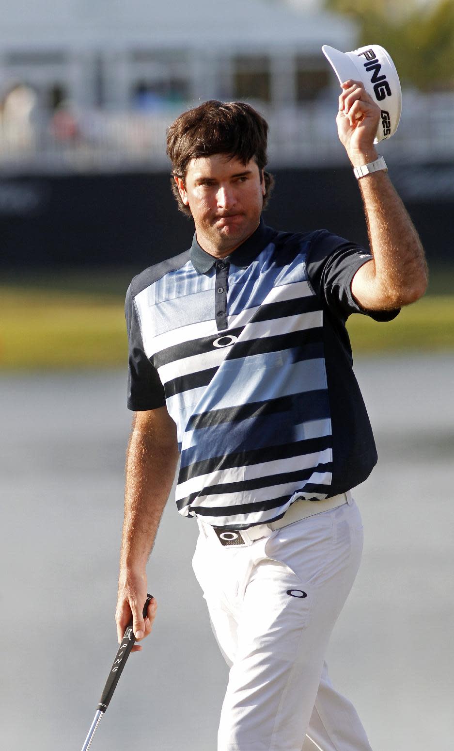Bubba Watson raises his hat on the 18th green during the final round of the Cadillac Championship golf tournament Sunday, March 9, 2014, in Doral, Fla. (AP Photo/Marta Lavandier)