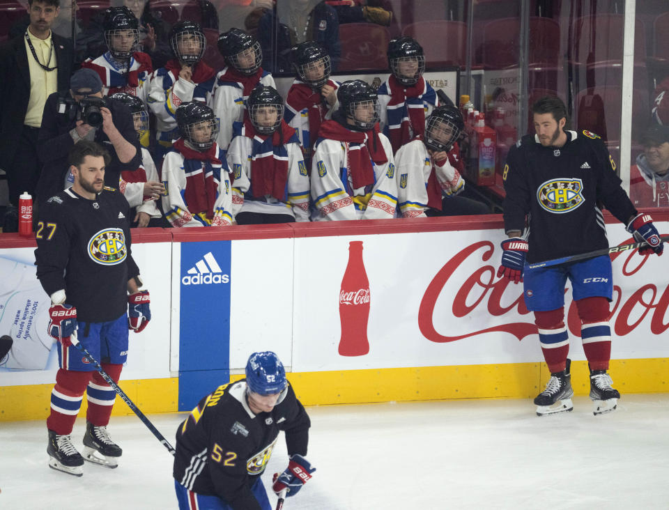 The Ukraine Select peewee team watch the Montreal Canadiens warmup before an NHL hockey game against the Chicago Blackhawks Tuesday, Feb. 14, 2023 in Montreal. (Ryan Remiorz/The Canadian Press via AP)