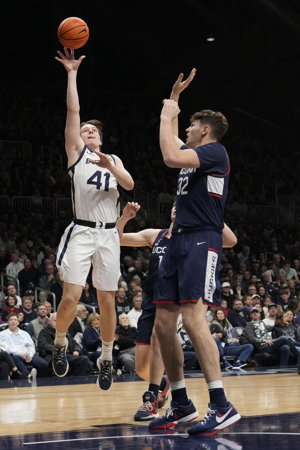 Butler guard Simas Lukosius (41) shoots in front of Connecticut center Donovan Clingan (32) in the first half of an NCAA college basketball game in Indianapolis, Saturday, Dec. 17, 2022. (AP Photo/AJ Mast)