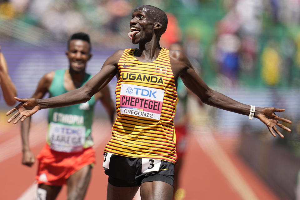 Joshua Cheptegei, of Uganda, reacts to winning the men's 10000-meter run final at the World Athletics Championships on Sunday, July 17, 2022, in Eugene, Ore. (AP Photo/Ashley Landis)