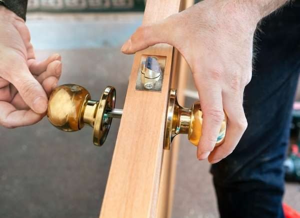 Removing a brass door handle from a wood door