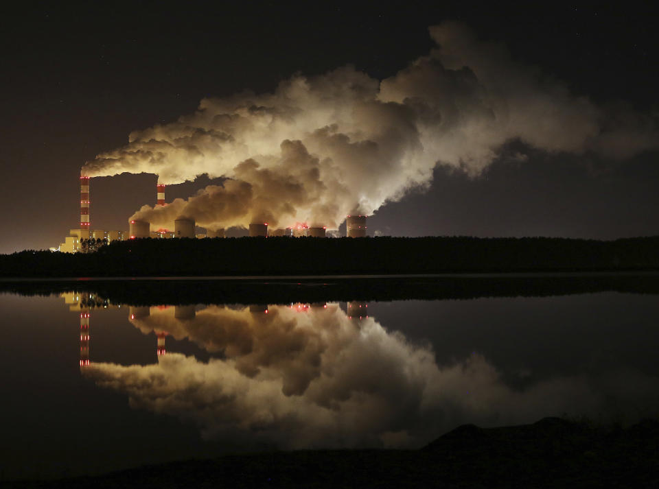 FILE - In this Wednesday, Nov. 28, 2018 file photo, plumes of smoke rise from Europe's largest lignite power plant in Belchatow, central Poland. As politicians haggle at a U.N. climate conference in Poland over ways to limit global warming, the industries and machines powering our modern world keep spewing their pollution into the air and water. The fossil fuels extracted from beneath the earth’s crust _ coal, oil and gas _ are transformed into the carbon dioxide that is now heating the earth faster than scientists had expected even a few years ago. (AP Photo/Czarek Sokolowski)