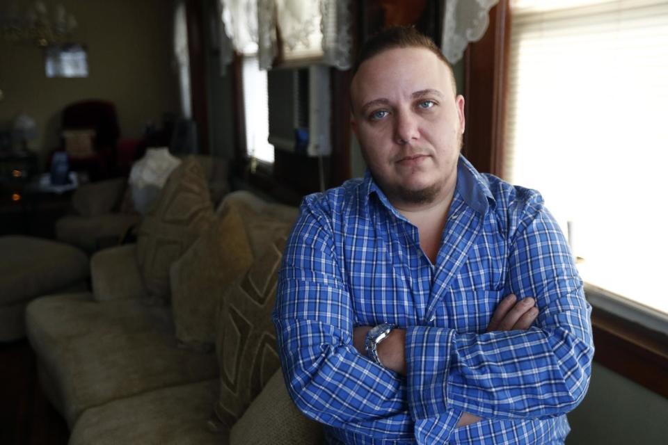 Jionni Conforti poses for The Associated Press in his home, Thursday, Jan. 5, 2017, in Totowa, N.J. The transgender man has sued St. Joseph's Regional Medical Center in Paterson, N.J., after he said it cited religion in refusing to allow his surgeon to perform a hysterectomy procedure he said was medically necessary as part of his gender transition. Conforti had scheduled the surgery in 2015, but he alleges in the federal lawsuit that a hospital administrator then told him the procedure to remove the uterus he was born with couldn't be done because it was a "Catholic hospital." (AP Photo/Julio Cortez)