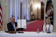 Ivanka Trump, right, applauds as President Donald Trump holds an executive order that he signed during a meeting with the American Workforce Policy Advisory Board, in the East Room of the White House, Friday, June 26, 2020, in Washington. (AP Photo/Evan Vucci)