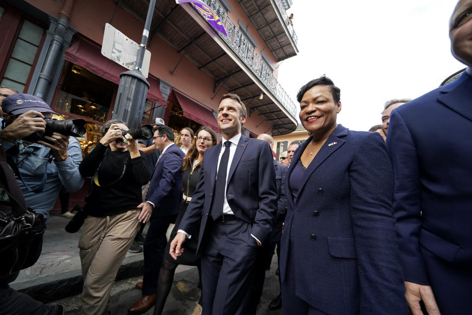 French President Emmanuel Macron walks down Royal St. with New Orleans Mayor Latoya Cantrell in the French Quarter of New Orleans, Friday, Dec. 2, 2022. (AP Photo/Gerald Herbert)