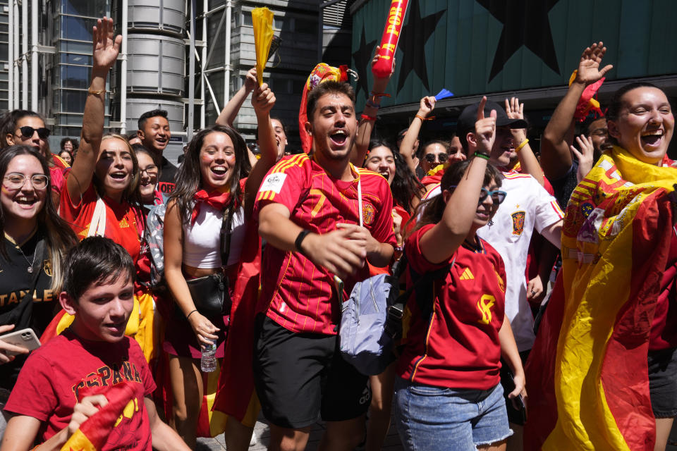 Spanish fans celebrate in a street, in Madrid, Spain, Sunday, Aug. 20, 2023, after Spain won against England in the Women's World Cup final soccer match played in Australia. (AP Photo/Paul White)