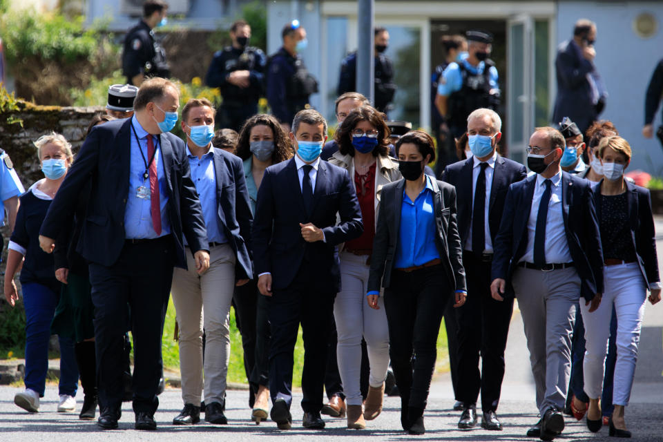 French Interior Minister Gerald Darmanin, center, arrive at the police station in La Chapelle-sur-Erdre, France, Friday, May 28, 2021. An unidentified assailant stabbed a police officer at her station Friday in western France then shot two other officers before being killed in a shootout with police, authorities said. (AP Photo/Laetitia Notarianni)