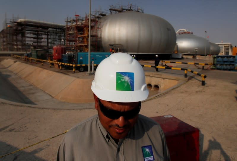 FILE PHOTO: An employee in a branded helmet is pictured at Saudi Aramco oil facility in Abqaiq